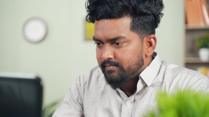 Frustrated young programmer closed laptop by seeing errors in code - concept of computer software crash or failure at workplace.