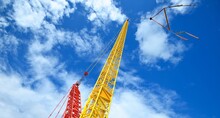 Arrow And Cabin Of A Mobile Crane Against Blue Sky. Concept Urban Scene. Industry, Ecological Issues, Environmental Damage