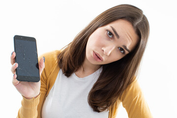 Beautiful young woman is upset about the broken phone