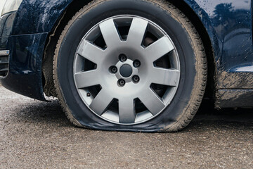 flat car tire close up, punctured wheel