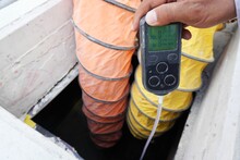 Construction Supervisor Hand Holding Gas Detector Device While Commencing Safety Gas Testing Atmosphere At Manhole To Work Construction Site