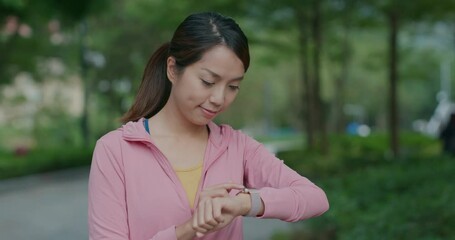 Wall Mural - Sport woman use of smart watch at park for jogging