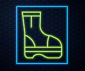 Sticker - Glowing neon line Fire boots icon isolated on brick wall background. Vector.