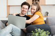 © Proxima Studio - Couple using home internet with mobile devices