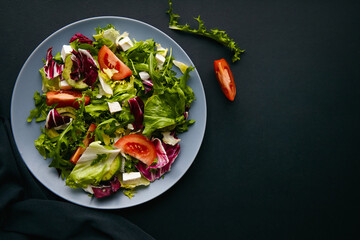 Wall Mural - Mix salad with tomatoes, feta, lettuce, spinach. Top view with text space