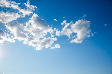 Blue sky background with abstract white clouds