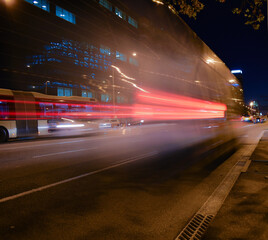 Wall Mural - Buses and cars moving at night on the road.