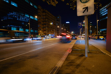 Poster - Buses and cars moving at night on the road.