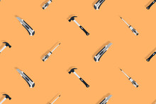 Tools Seamless Pattern. Tools: Hammer, Screwdriver And Knife On An Orange Background.