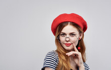 Happy Woman In A Red Beret And In A Striped T-shirt With Makeup On Her Face