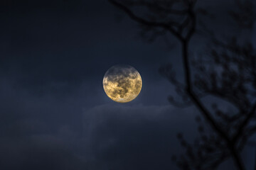 Full Moon December 2020, the last full moon of the decade, rising over mountain at dusk