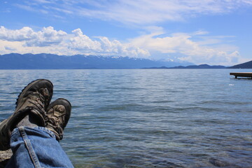 Montana lake with tired hiker resting