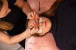 © kjekol - Woman Going Through Eyelash Extension Procedure in Beauty Clinic
