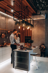 Canvas Print - The guy and the girl celebrate the New Year. A married couple retired in a cozy studio setting. Location in the kitchen.