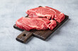 Two Fresh Raw meat Prime Black Angus Beef Steaks, Rib Eye, Denver, on wooden cutting board