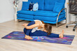 © boomeart - Full length portrait of young woman doing yoga pose on a floor