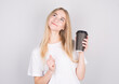 © Studio Nova - young woman holding a mug of coffee looking up. Woman drinks coffee dreaming. Relaxing and thinking over a cup of coffee.