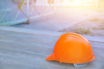 Wall Mural - yellow safety helmet on wooden floor in construction site