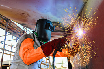 Welders, Ship repair industry Workers Welders is Welding with spark light wear equipment protective in shipyard.