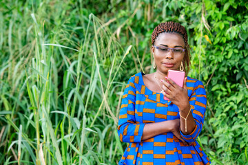 portrait of a beautiful woman with mobile phone in a park, smili