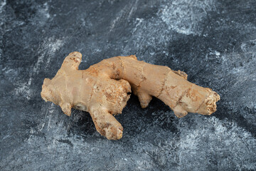 Single fresh ginger on marble background