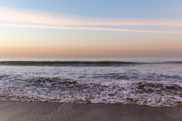 Canvas Print - Waves washing ashore in colorful sunrise at Malibu Beach, California