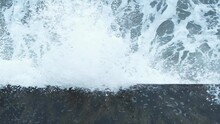 Top View Of Waves Crashing On A Wall And Splashing. Slow Motion.