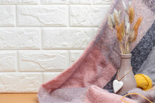 Knitted Scarf With A Ceramic Vase With A Heart With Hare Tails And A Yellow Spool Of Thread. Cozy Wallpapers, Home Atmosphere, Copy Space