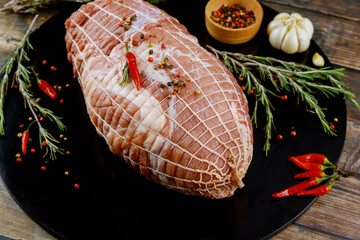 Wall Mural - Close up view of pork shoulder on black wooden board.