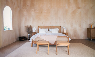 Interior of bedroom with wooden double bed white pillows. wood  wall in the room in rustic cottage. Stylish and comfort hotel accommodation with copy space