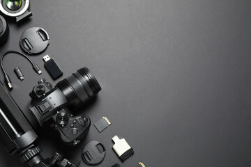 Wall Mural - flat lay composition with camera and video production equipment on black background. space for text