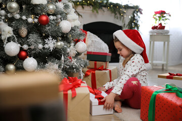 Wall Mural - Cute little girl with Christmas gift on floor at home