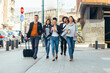 © qunica.com - Friends Bonding, group of multi-ethnic friends walking on the streets talking to each other and smiling.