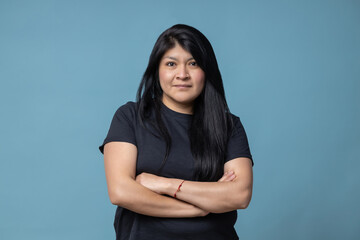 mexican latin woman arms crossed isolated blue background
