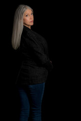 Wall Mural - Image of a beautiful mature blond woman in the studio. Studio image with a black background.