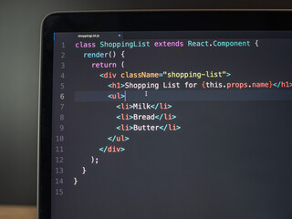 React coding on computer laptop screen close up