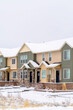 © Jason - Two storey apartment facade with snowy yard and roof against white sky in winter
