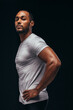© Jacob Lund - Side view portrait of a fit man on black background