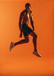 © Jacob Lund - Muscular man jumping in air during workout