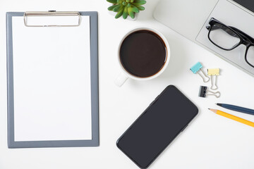 Wall Mural - flat lay of white office desk table or workplace with laptop, and smartphone and coffee cup with equ
