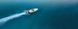Aerial drone top down ultra wide photo of inflatable power rib boat making extreme manoeuvres in Mediterranean bay with deep blue sea at dusk