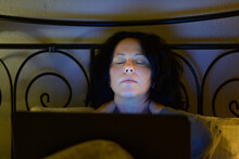Tired Woman Taking A Nap As She Works At Night