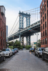  Manhattan bridge seen from a narrow alley of Brooklyn on a summer day