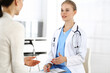 © Iryna - Woman - doctor consults her female patient in clinic. Medicine concept