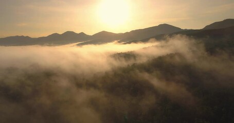 Wall Mural - Beautiful sunrise cloudy sky from aerial view. Above clouds from airplane window. panorama clouds cape. Aerial shot above the white clouds. 