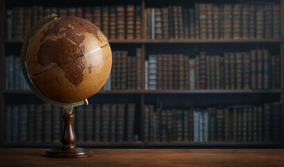 old geographic globe in the cabinet against the background of bookselfs.science, education, travel, 