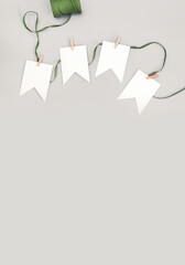 White paper garland cut against a bright beige wall background