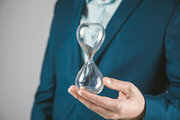 young business man holding hourglass