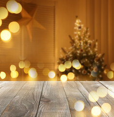 Canvas Print - Empty wooden surface and blurred view of room decorated for Christmas, space for text. Interior design