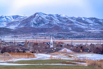 Canvas Print - Community in the snow dusted valley with scenic lake and majestic mountain view